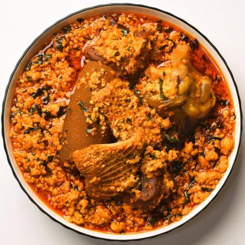 Egusi soup with assorted meat in a bowl